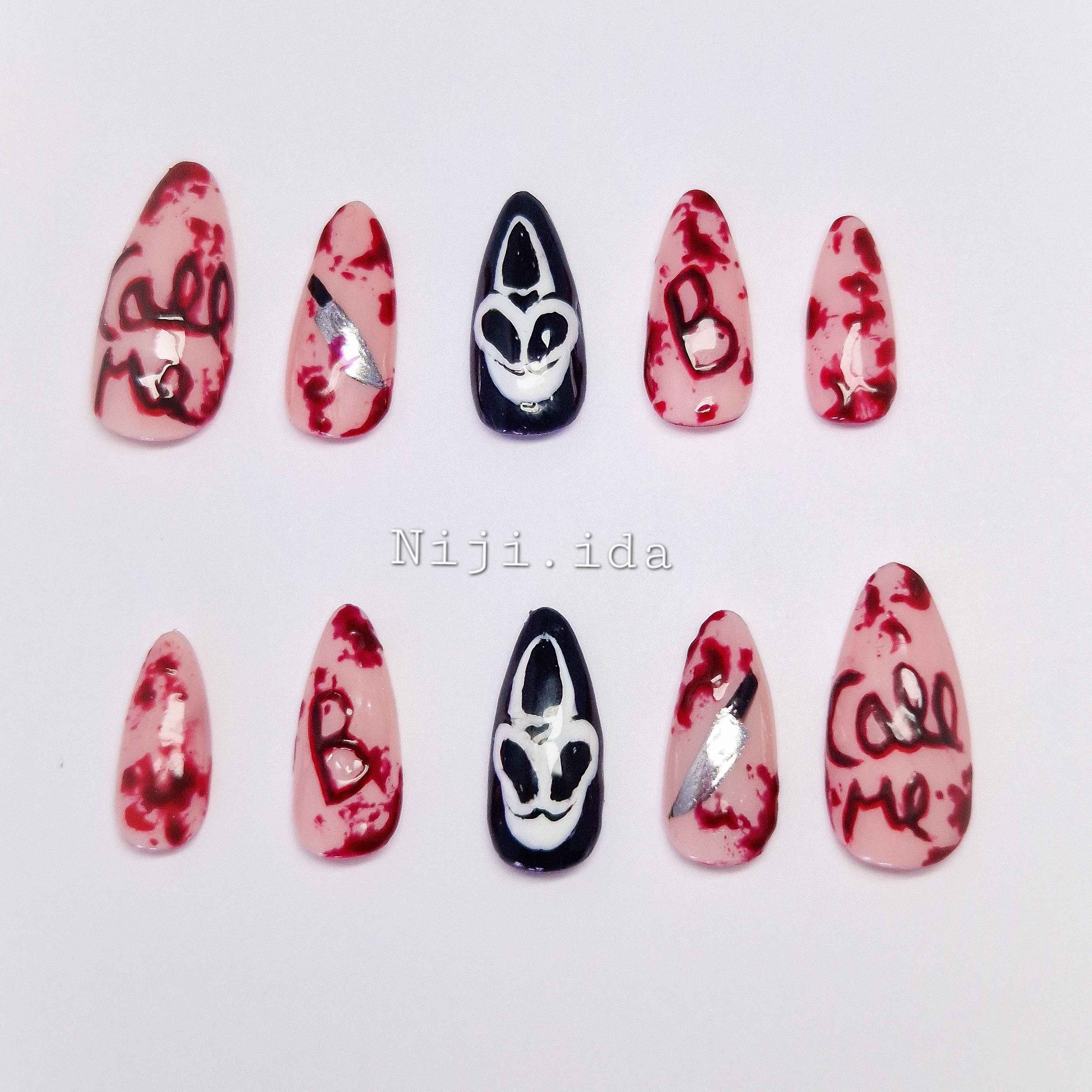 Set of nail art designs with red and black patterns on a white background.